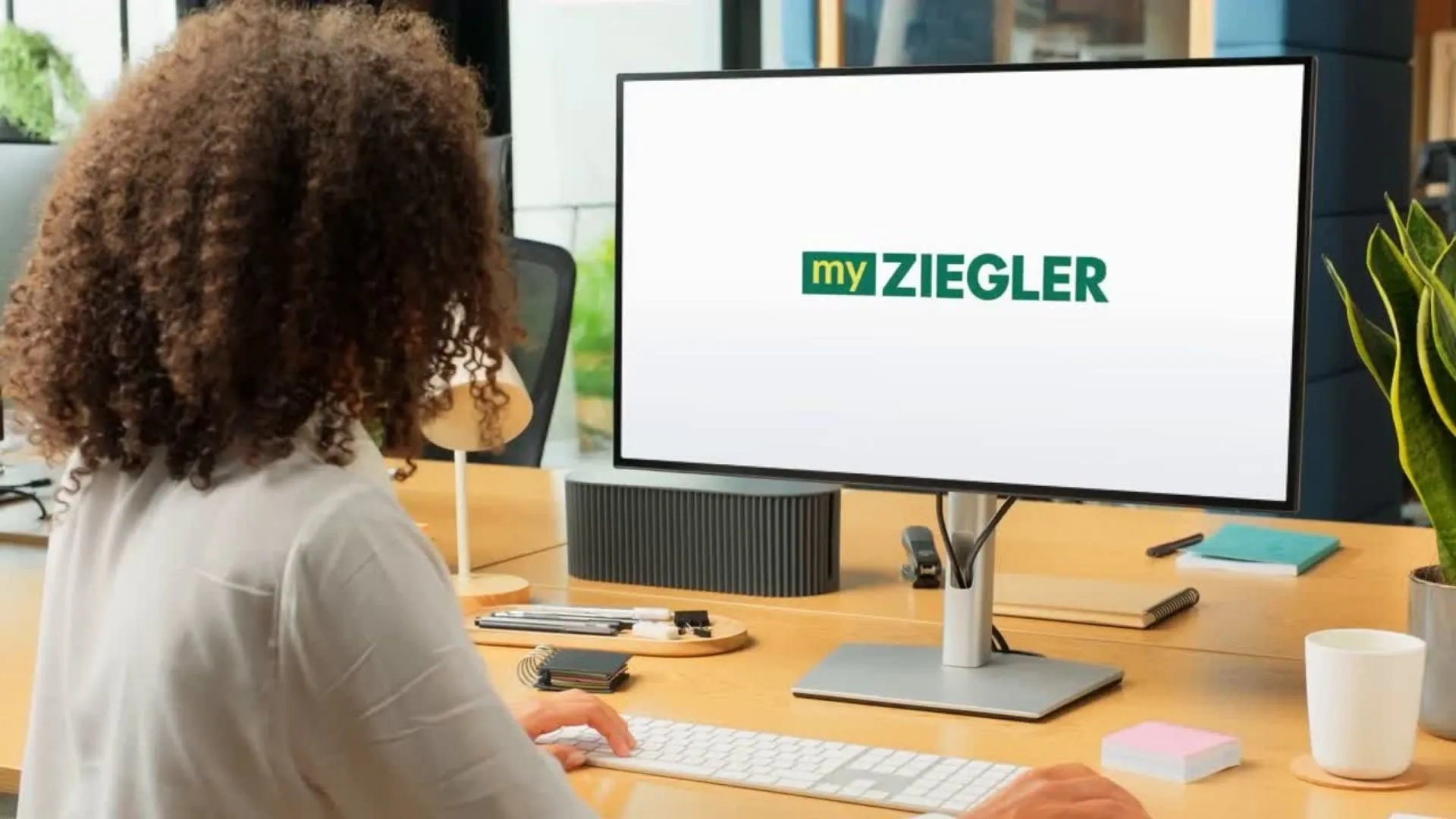 Woman at desk using computer with 