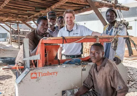 Jake with a sawmill crew around a portable sawmill