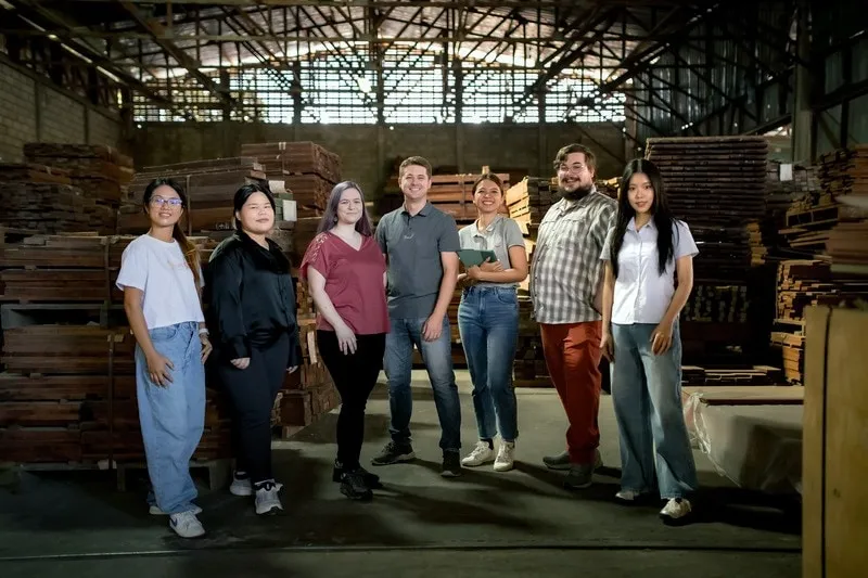 The Green Light Studio team in a timber warehouse